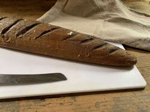 A Carved Bakers Window Display Of A French Baguette