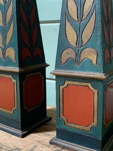 A DECORATIVE PAIR OF POLYCHROME PAINTED OBELISKS