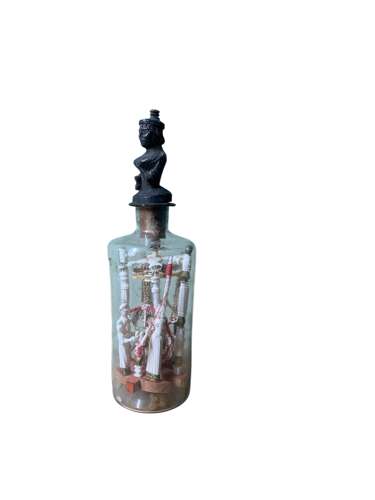 A RARE P.O.W BOTTLE WHIMSEY WITH CARVED AFRICAN FINIAL