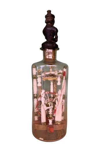 A RARE P.O.W BOTTLE WHIMSEY WITH CARVED AFRICAN FINIAL