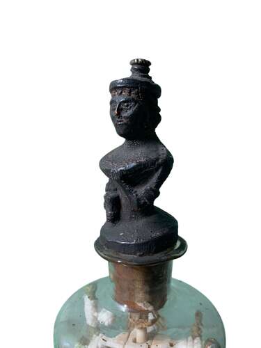A RARE P.O.W BOTTLE WHIMSEY WITH CARVED AFRICAN FINIAL