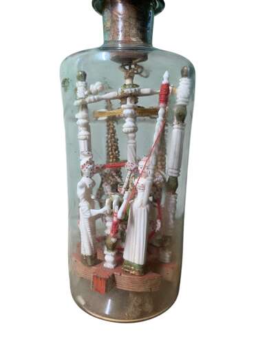 A RARE P.O.W BOTTLE WHIMSEY WITH CARVED AFRICAN FINIAL