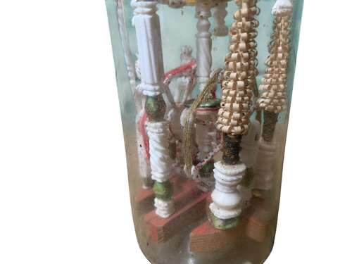 A RARE P.O.W BOTTLE WHIMSEY WITH CARVED AFRICAN FINIAL