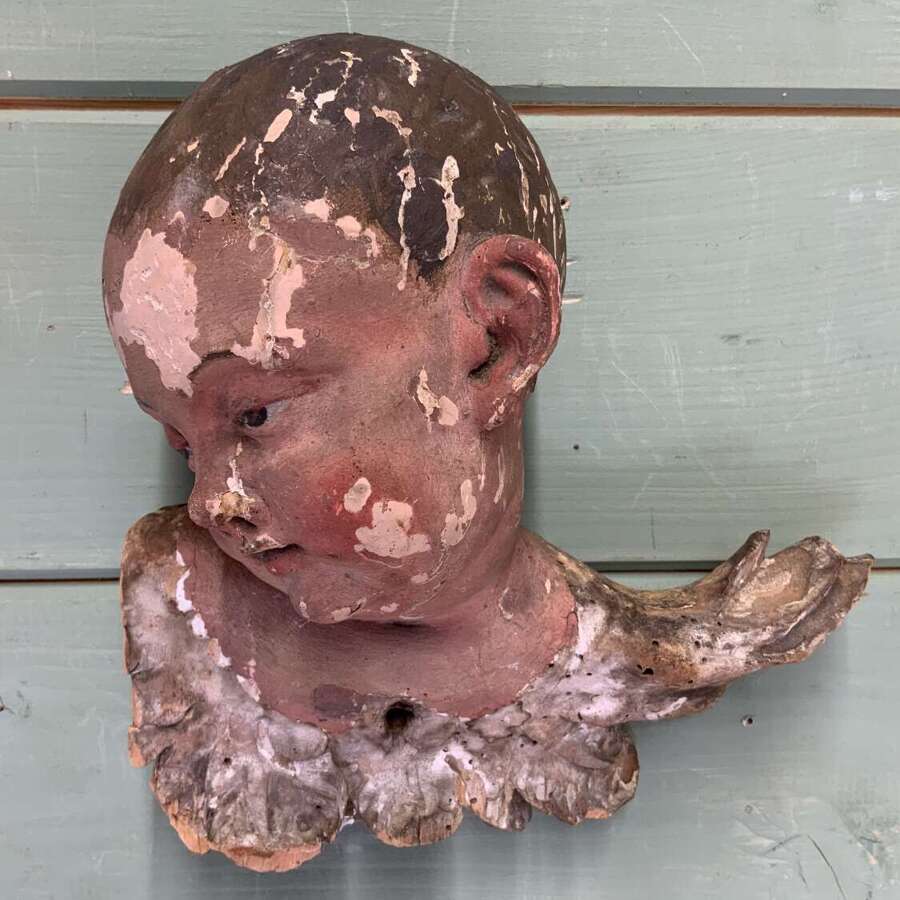 AN EARLY 18th C FRENCH CARVING OF A PUTTO