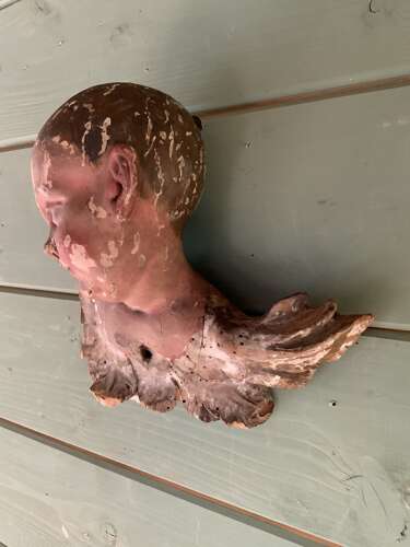 AN EARLY 18th C FRENCH CARVING OF A PUTTO